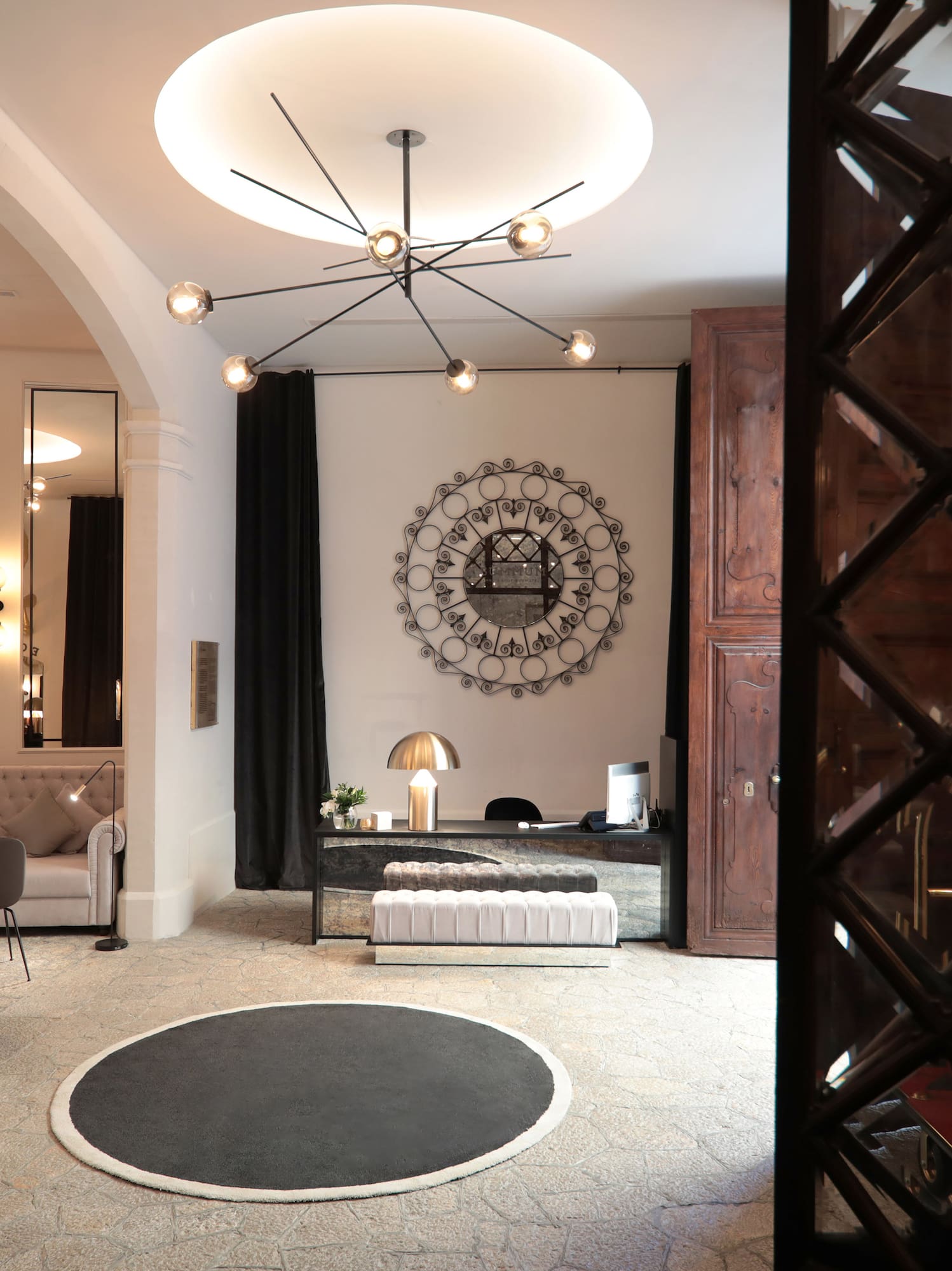 a room with a round rug and a mirror