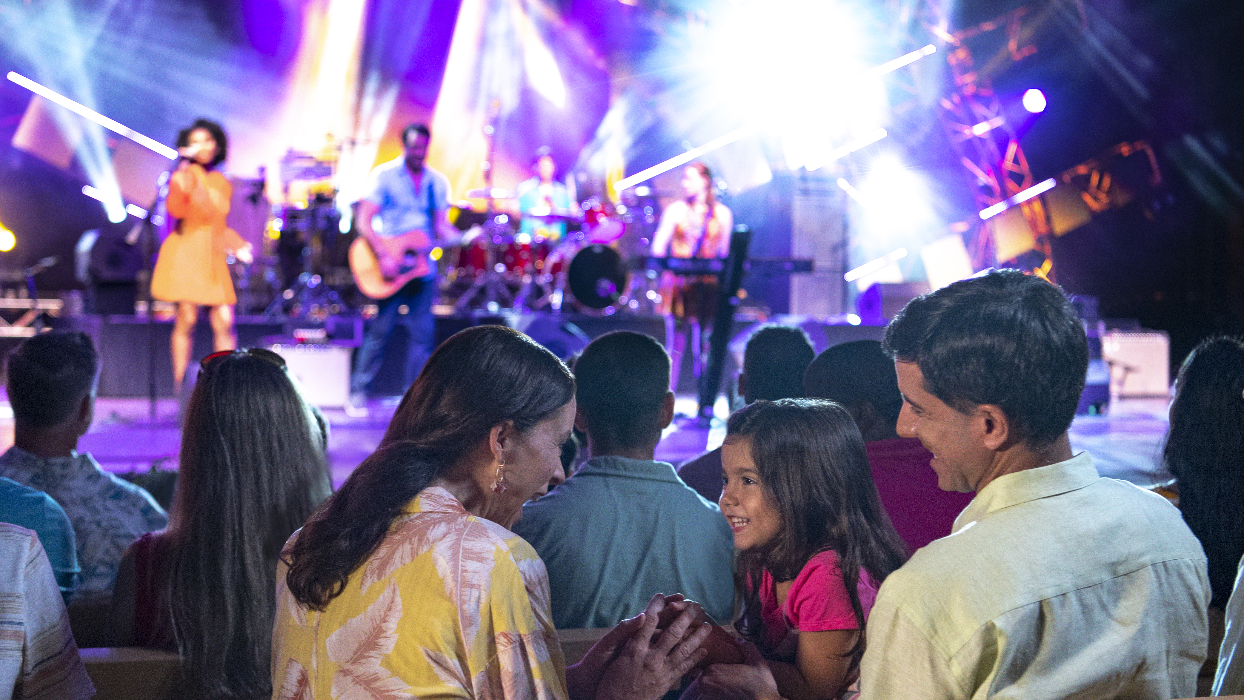 a group of people in front of a stage