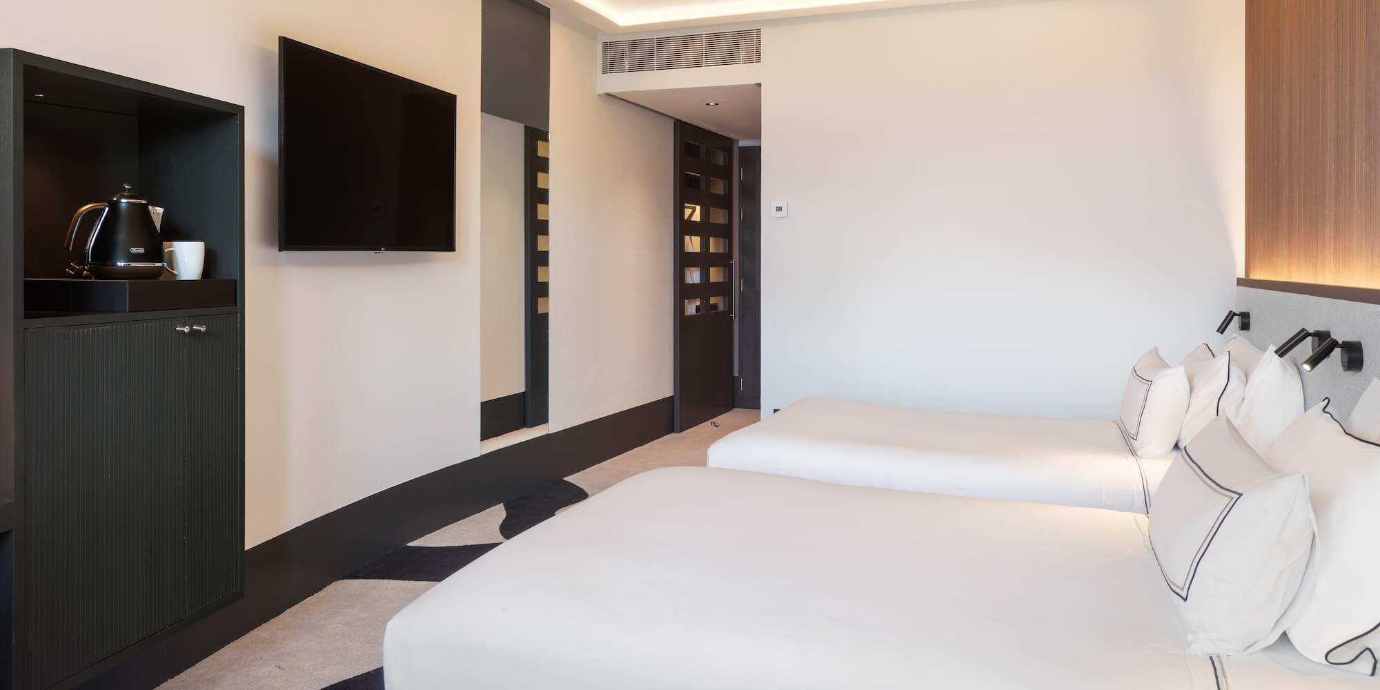 a room with two beds and a tv