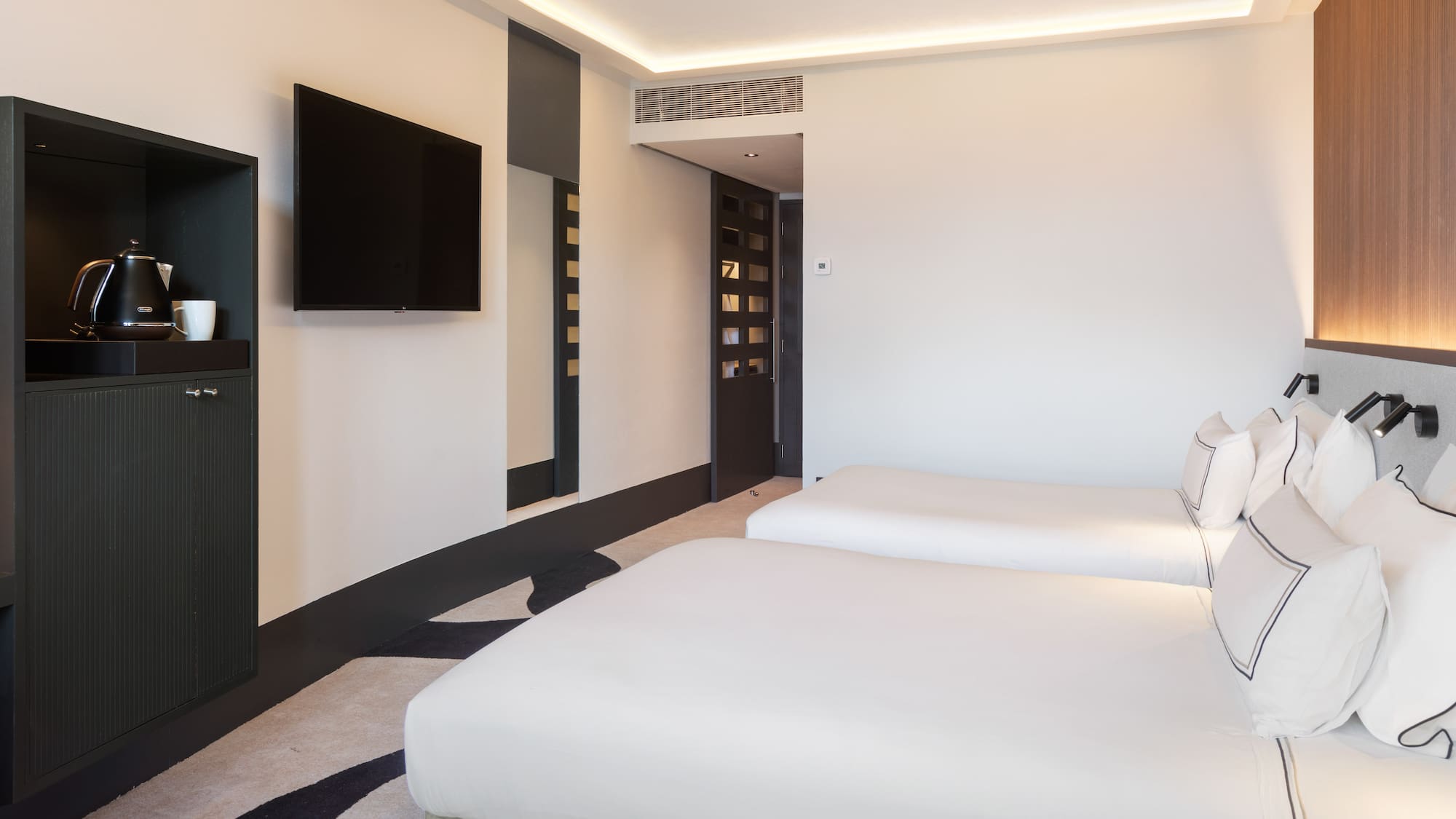 a room with two beds and a tv