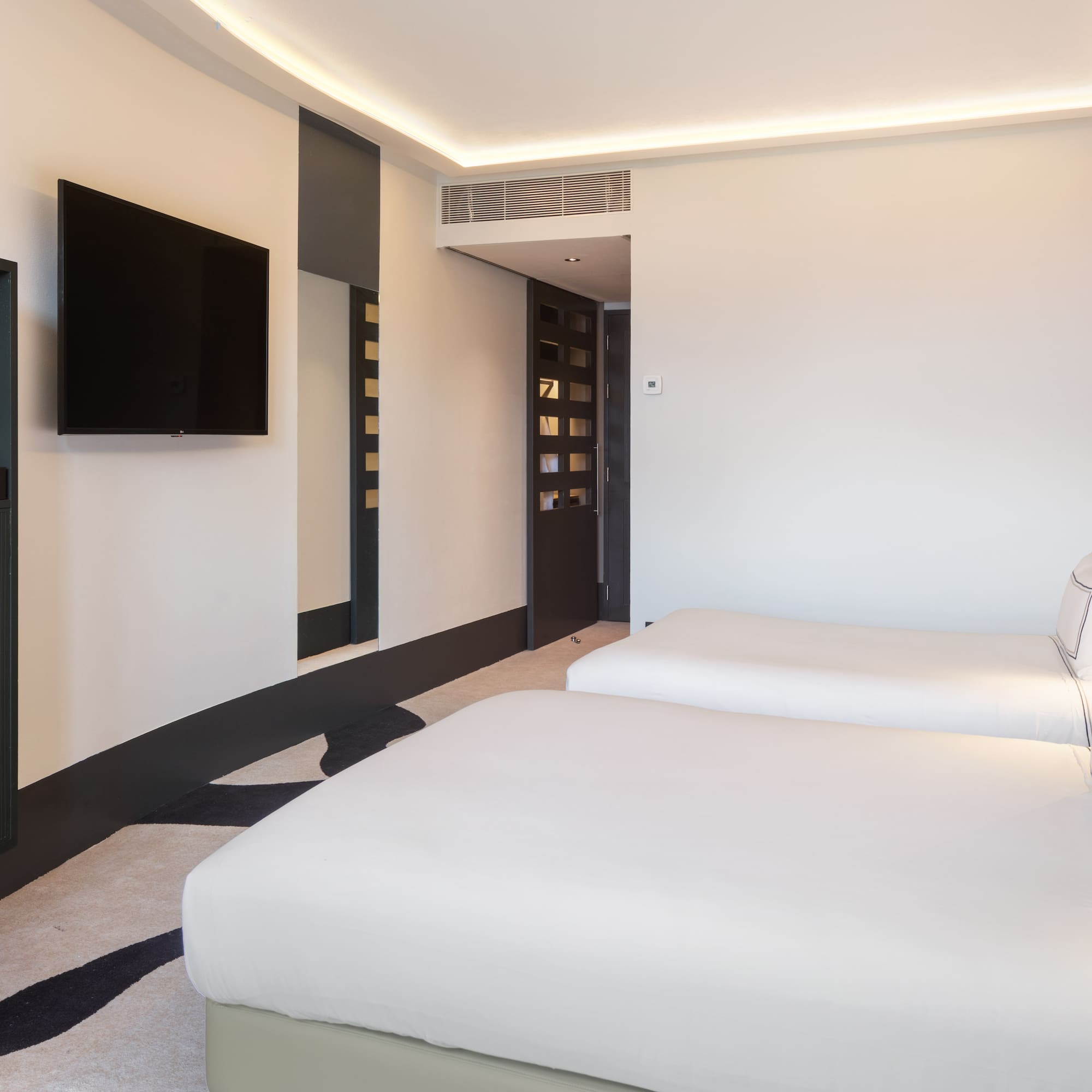 a room with two beds and a tv