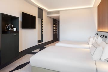 a room with two beds and a tv