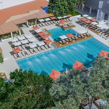 a swimming pool with chairs and umbrellas