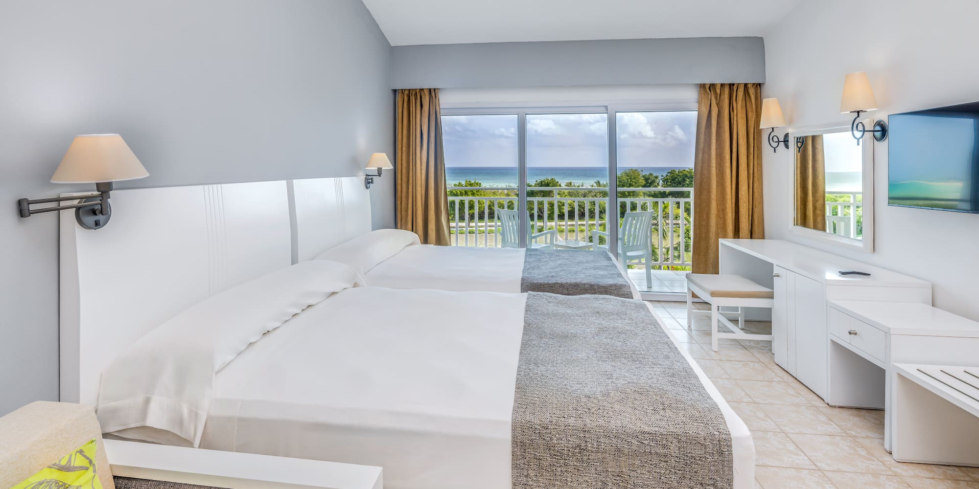 a room with two beds and a balcony