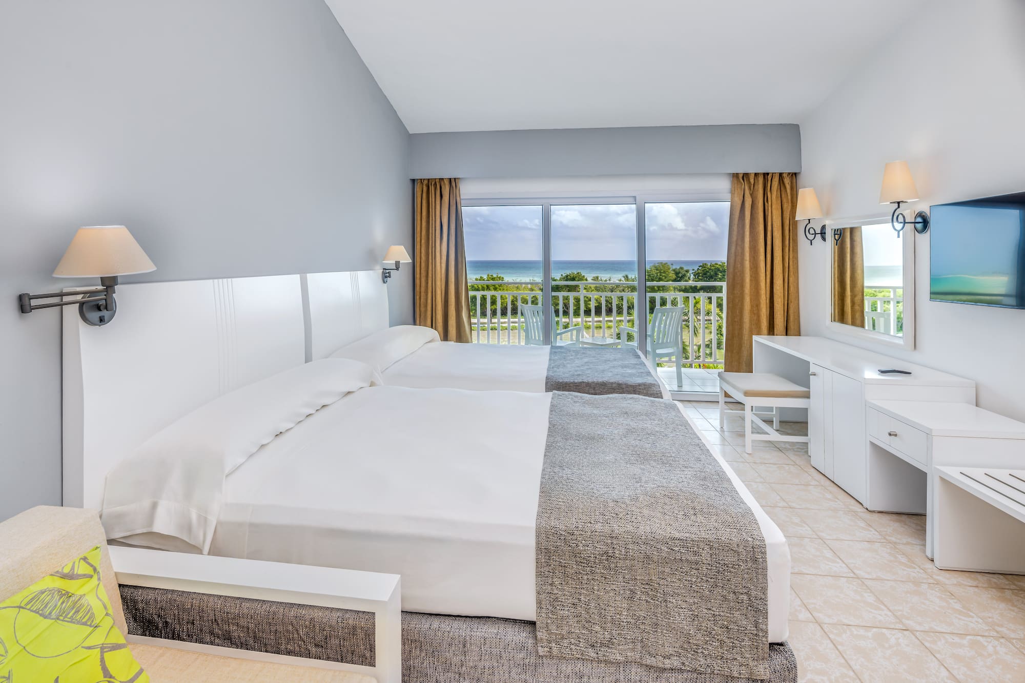 a room with two beds and a balcony