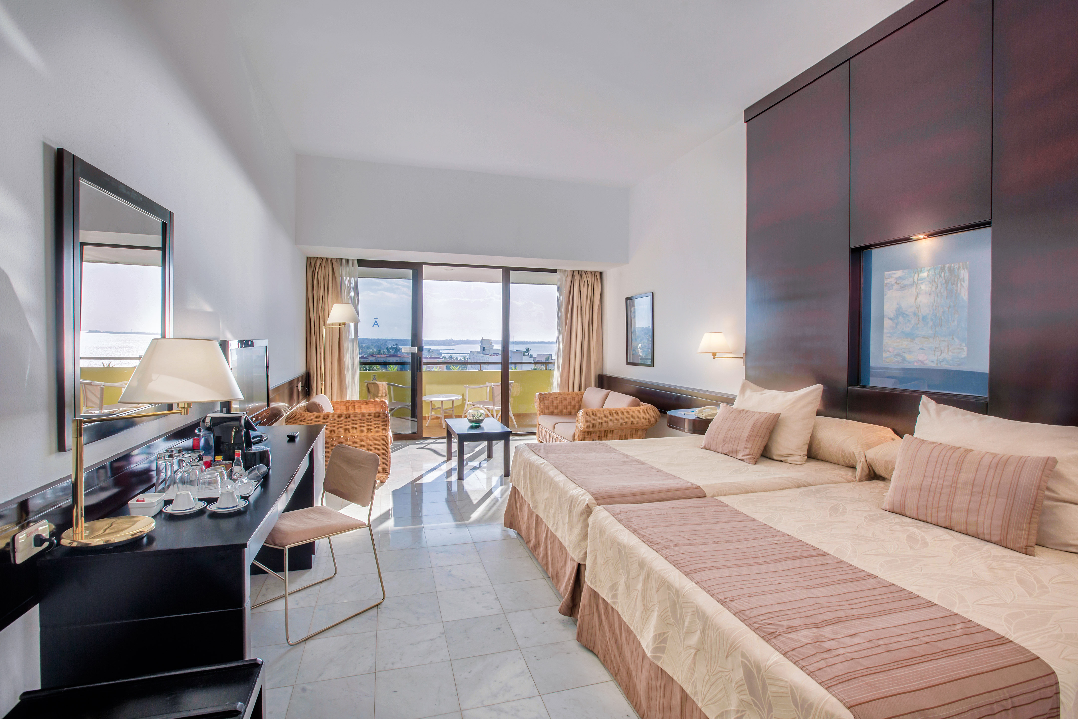 a room with two beds and a television