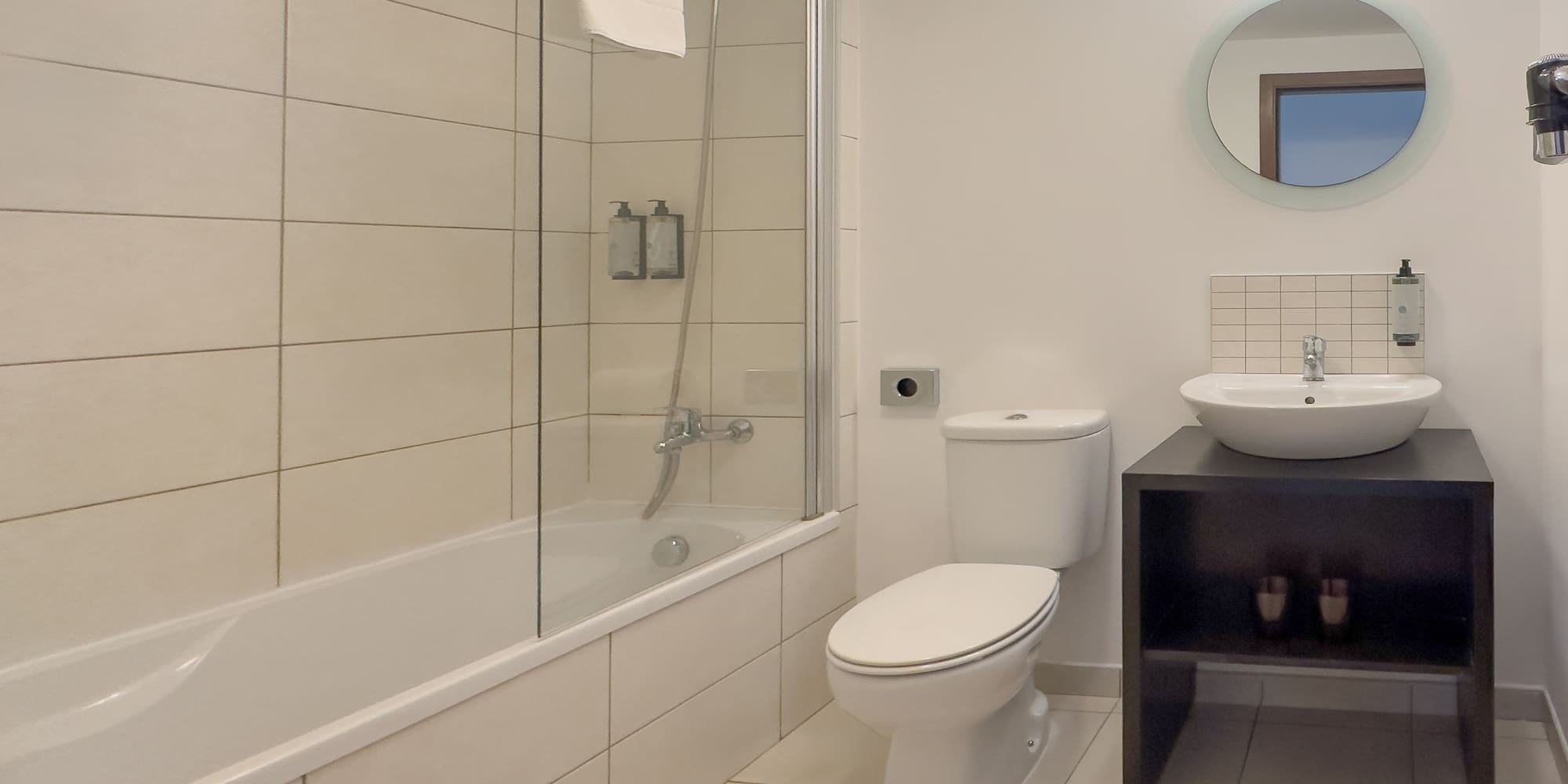 a bathroom with a tub and toilet