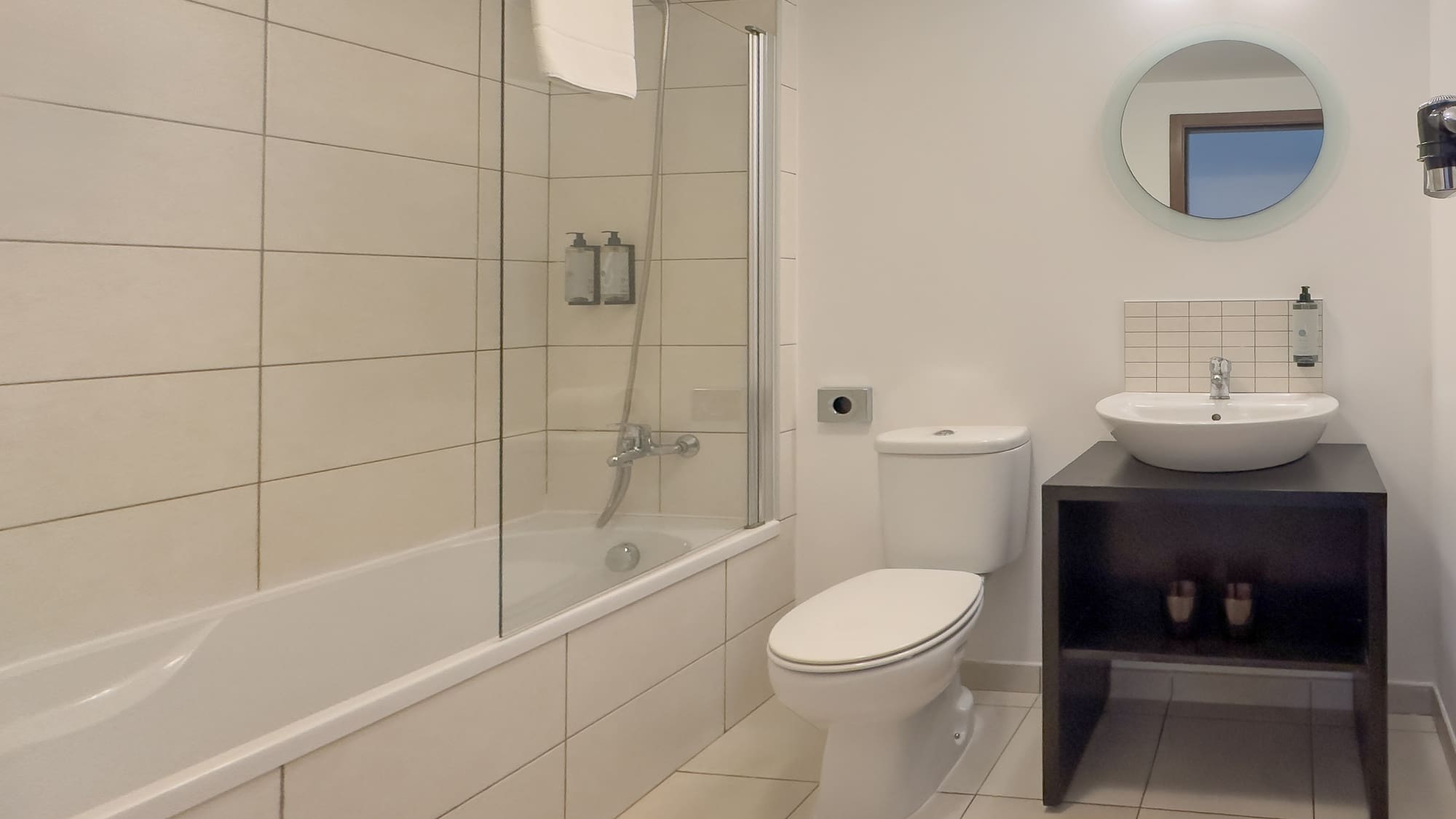 a bathroom with a tub and toilet