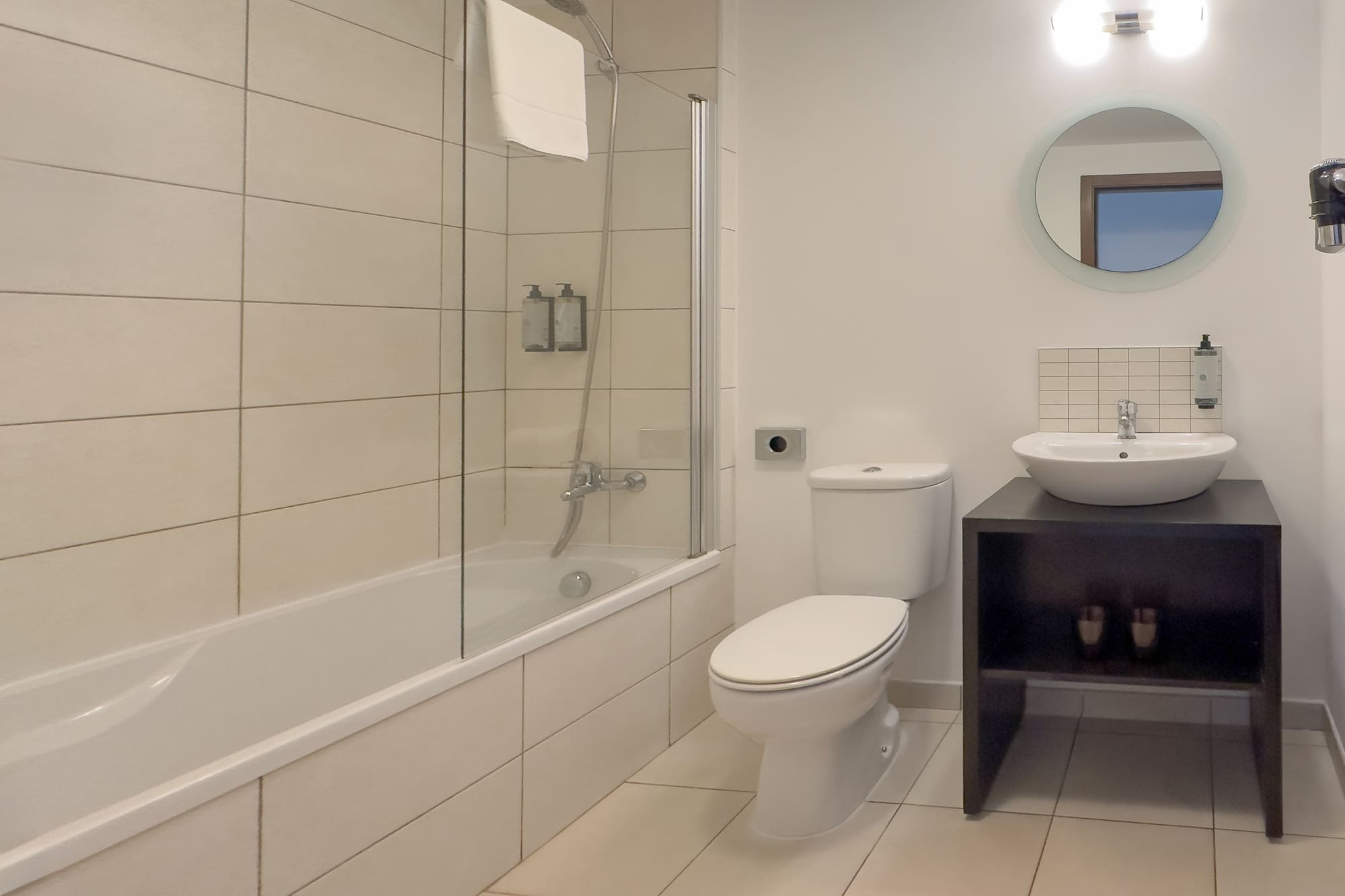 a bathroom with a tub and toilet
