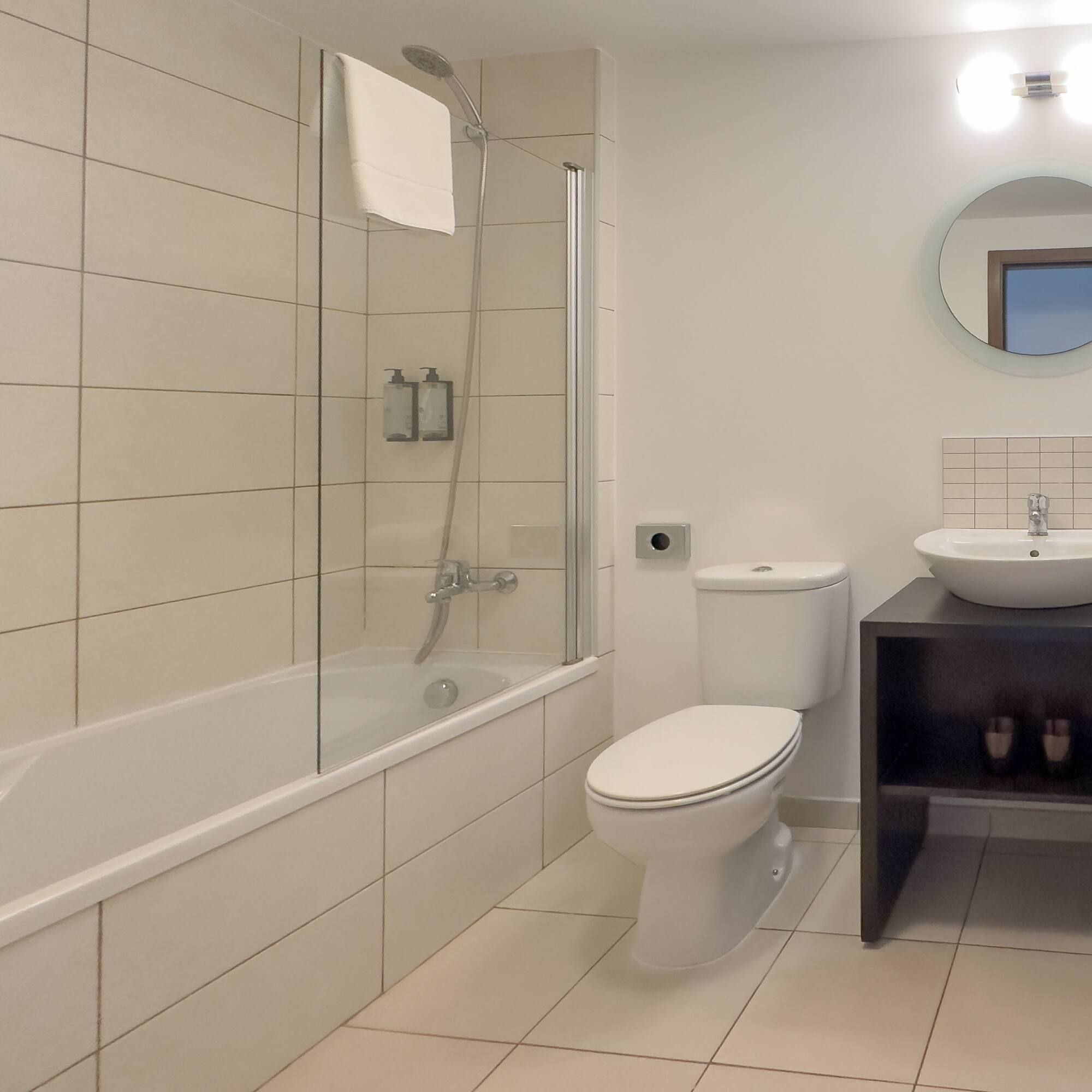 a bathroom with a tub and toilet