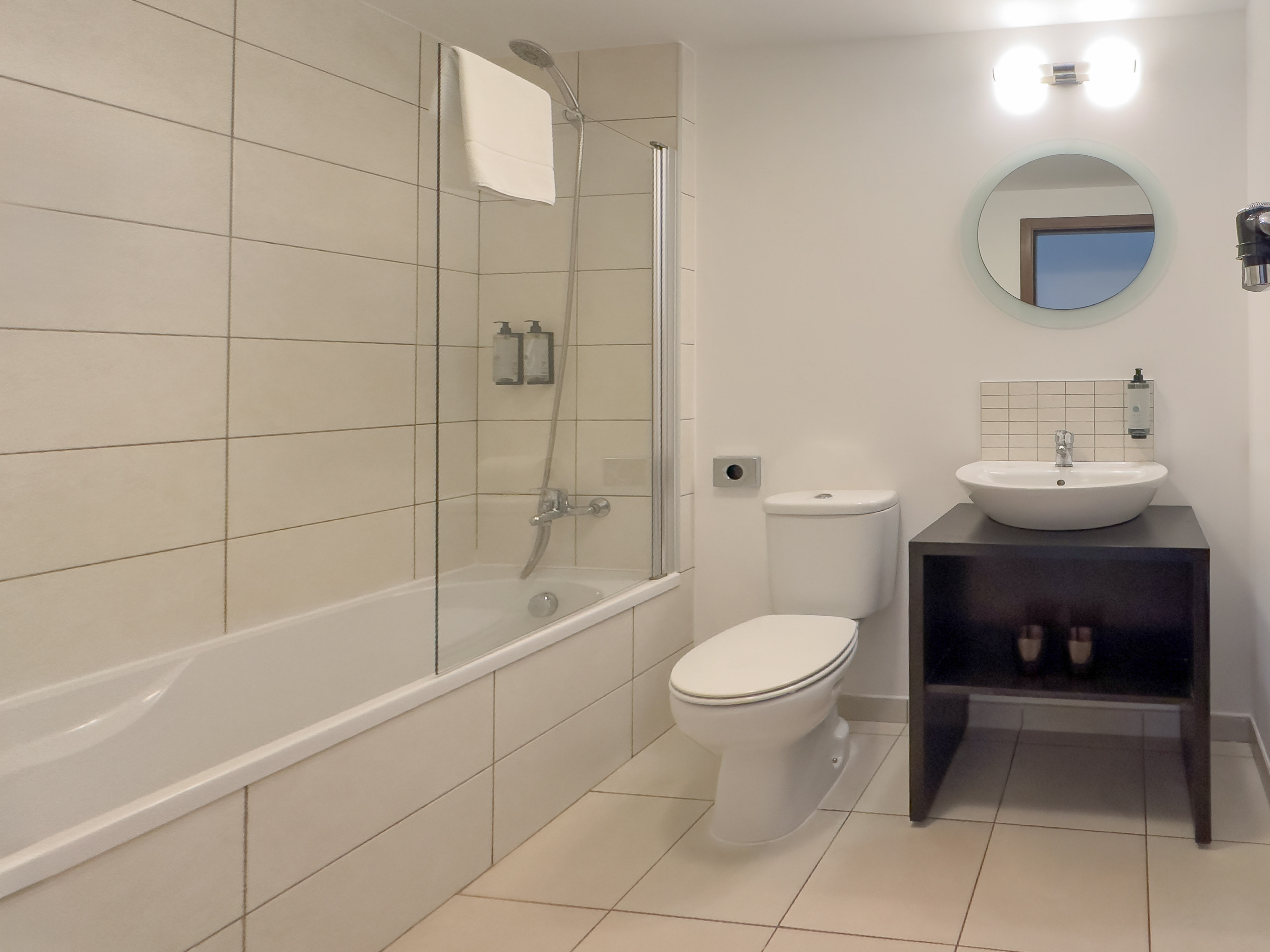 a bathroom with a tub and toilet