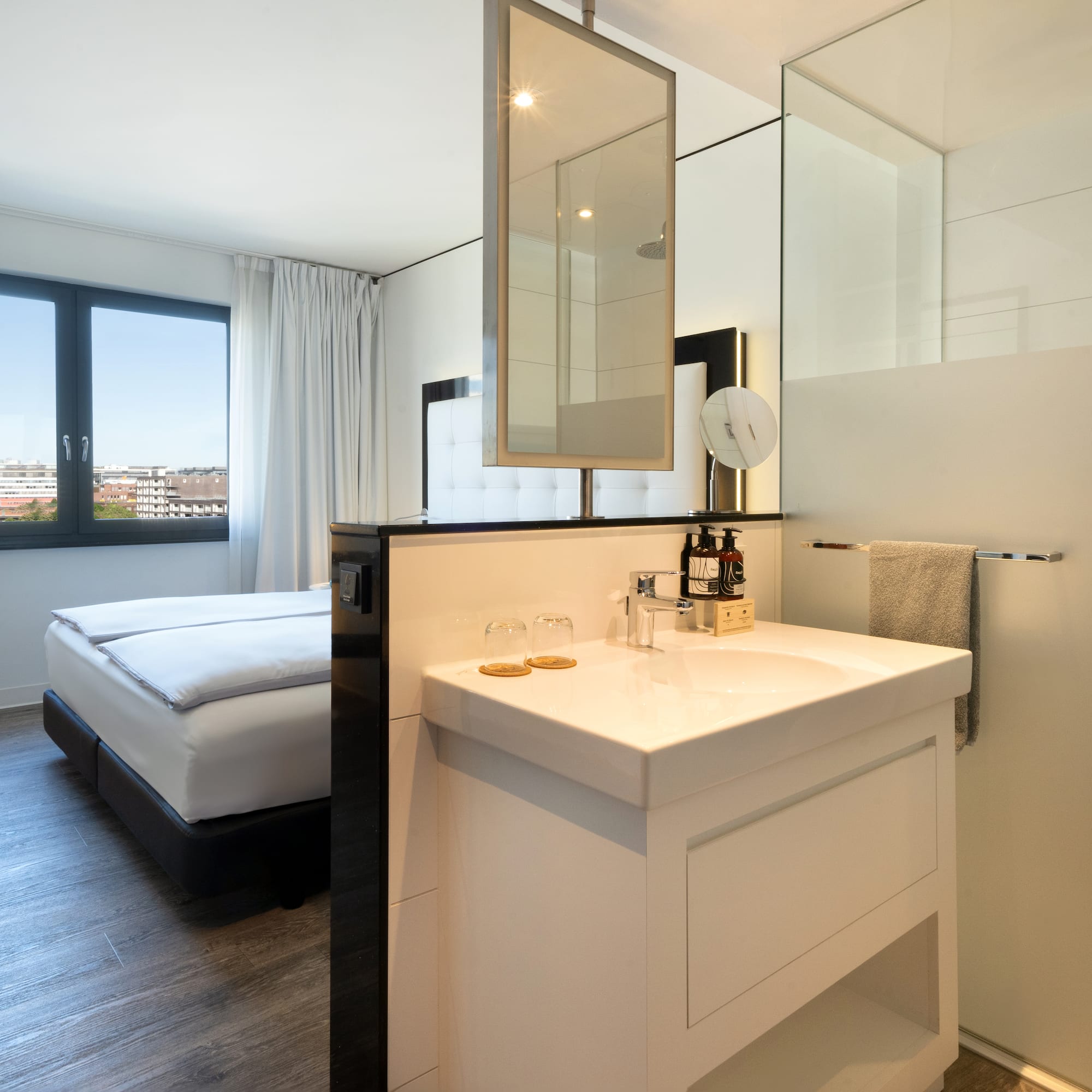 a bathroom with a bed and a sink