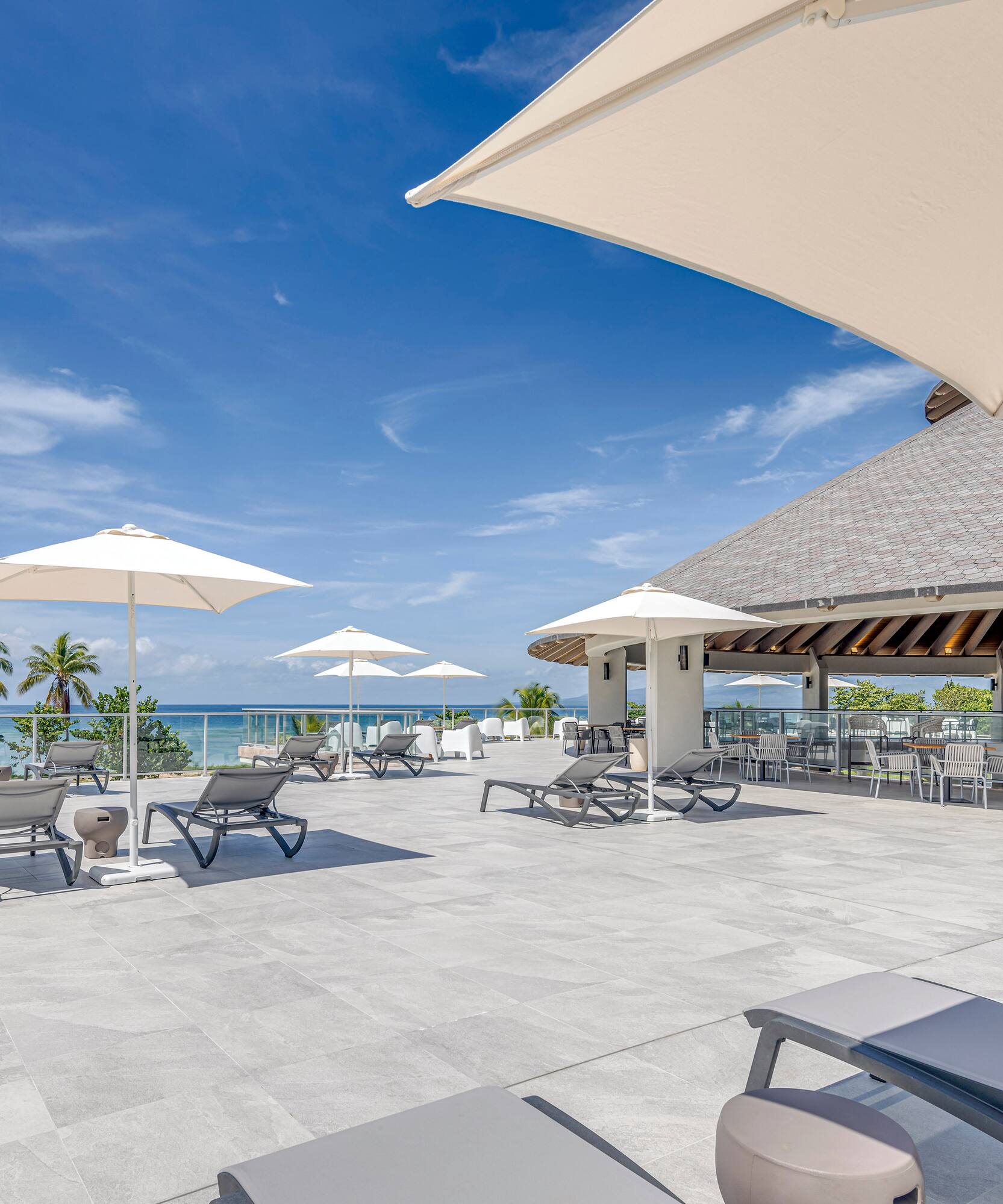 a large patio with chairs and umbrellas
