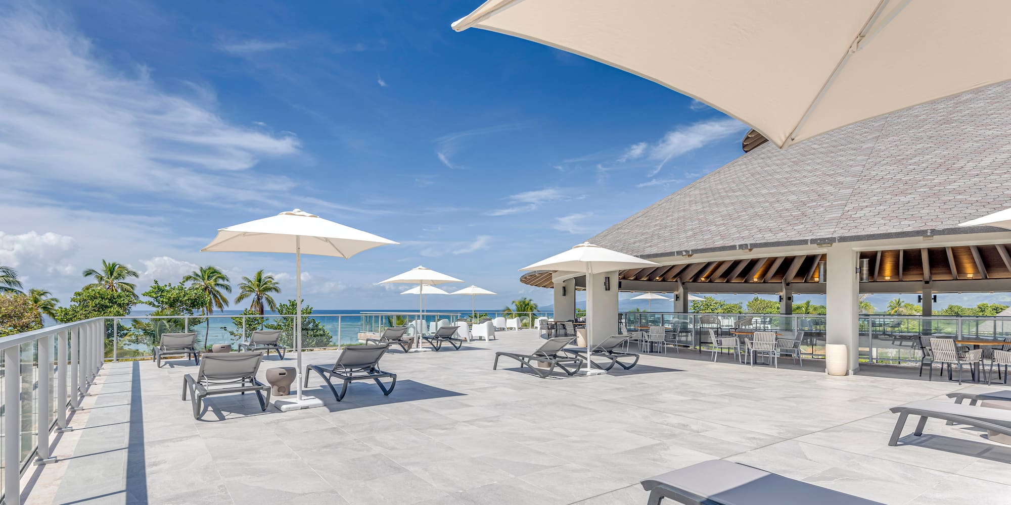 a large patio with chairs and umbrellas