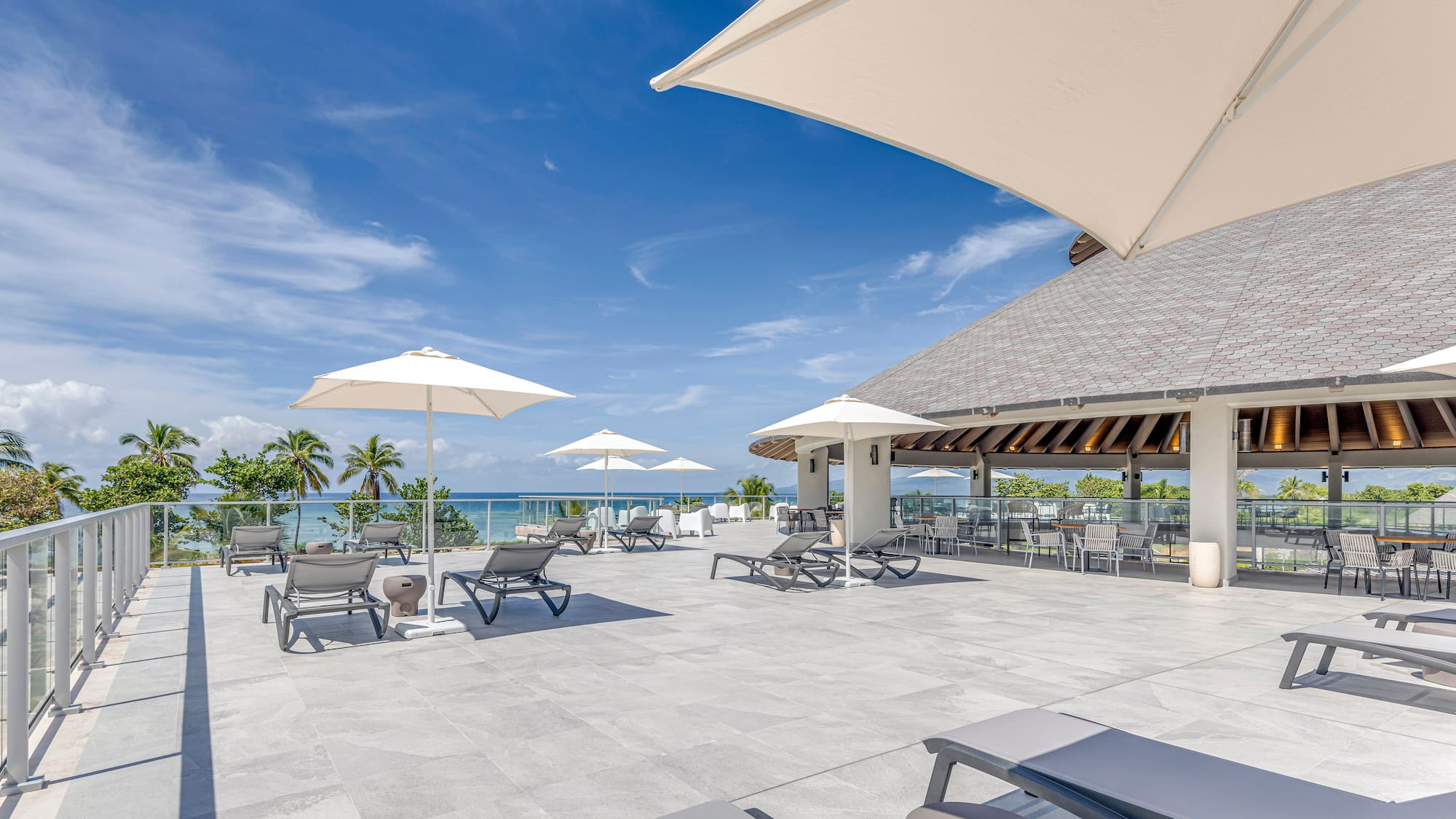 a large patio with chairs and umbrellas