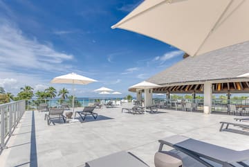 a large patio with chairs and umbrellas