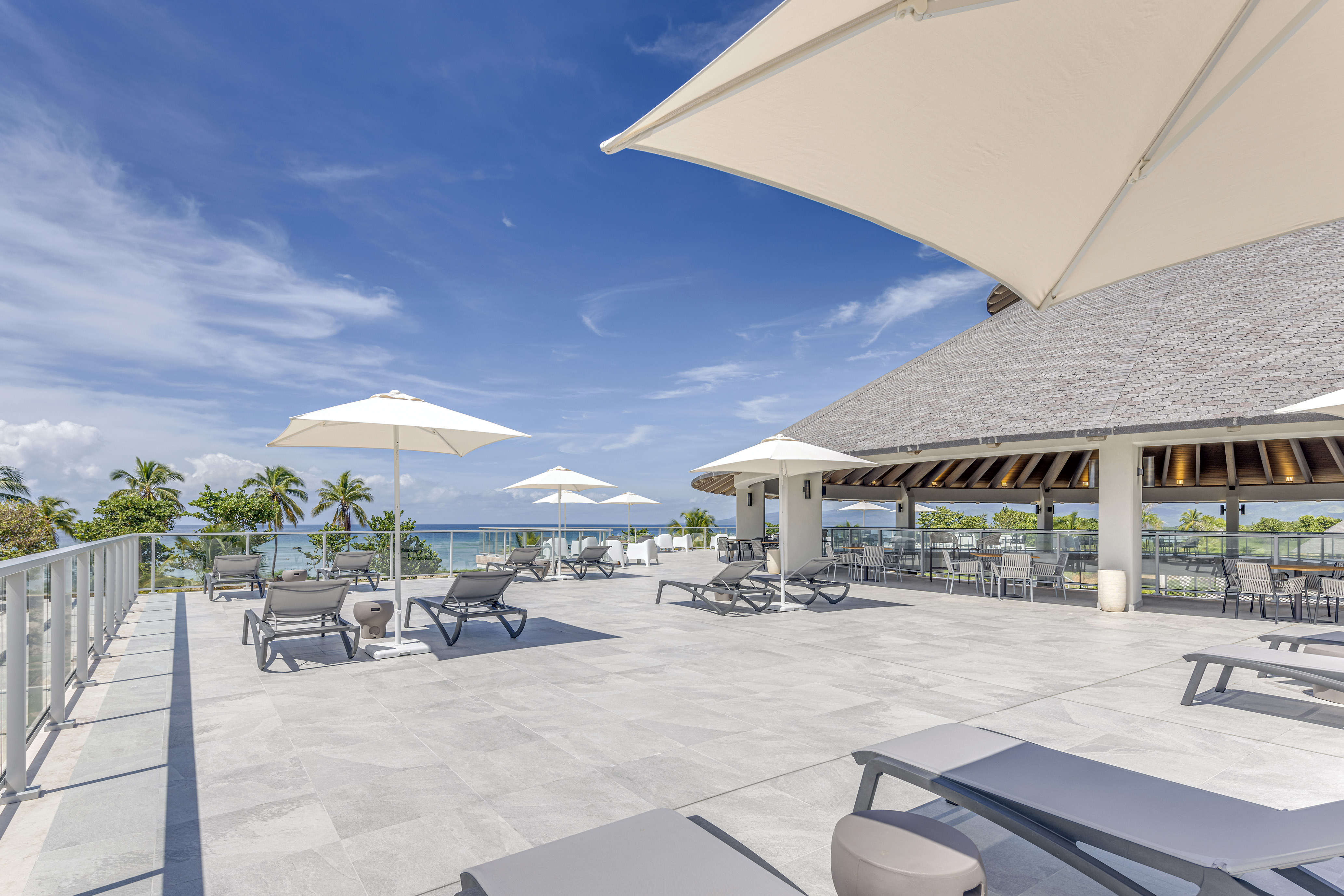 a large patio with chairs and umbrellas