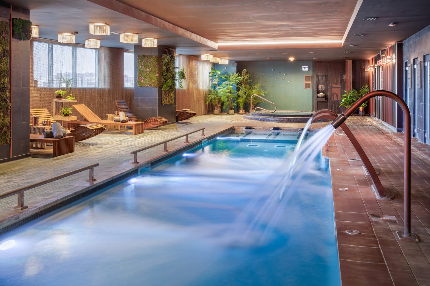 a swimming pool with a waterfall