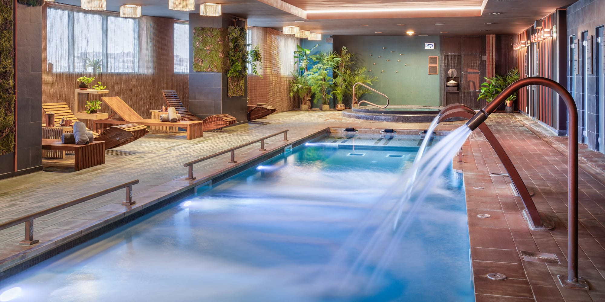 a swimming pool with a waterfall