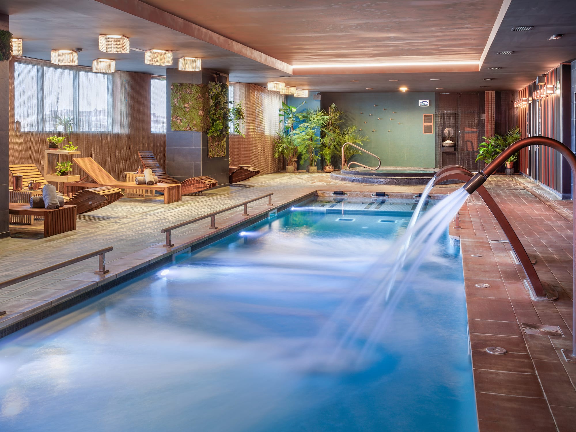 a swimming pool with a waterfall