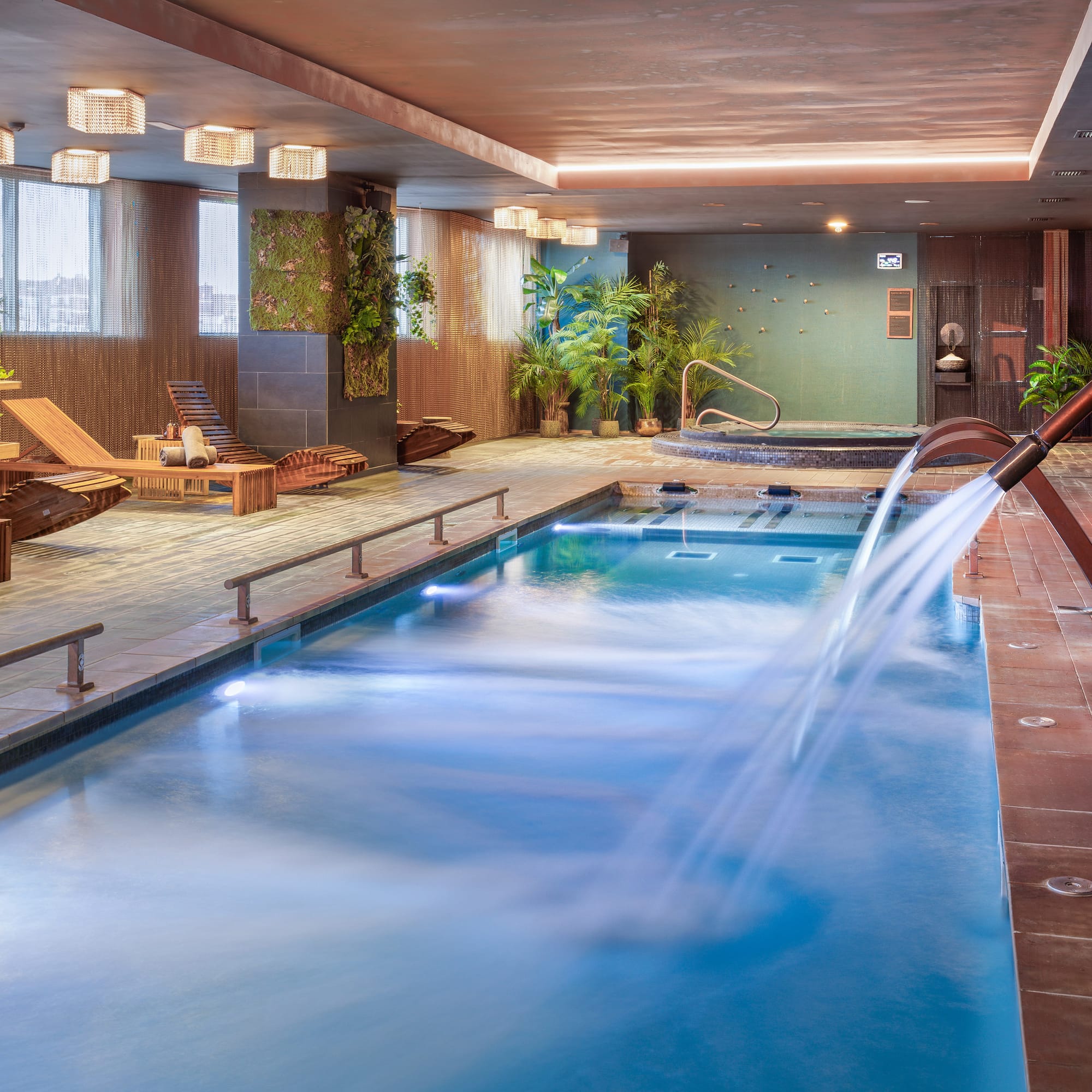 a swimming pool with a waterfall