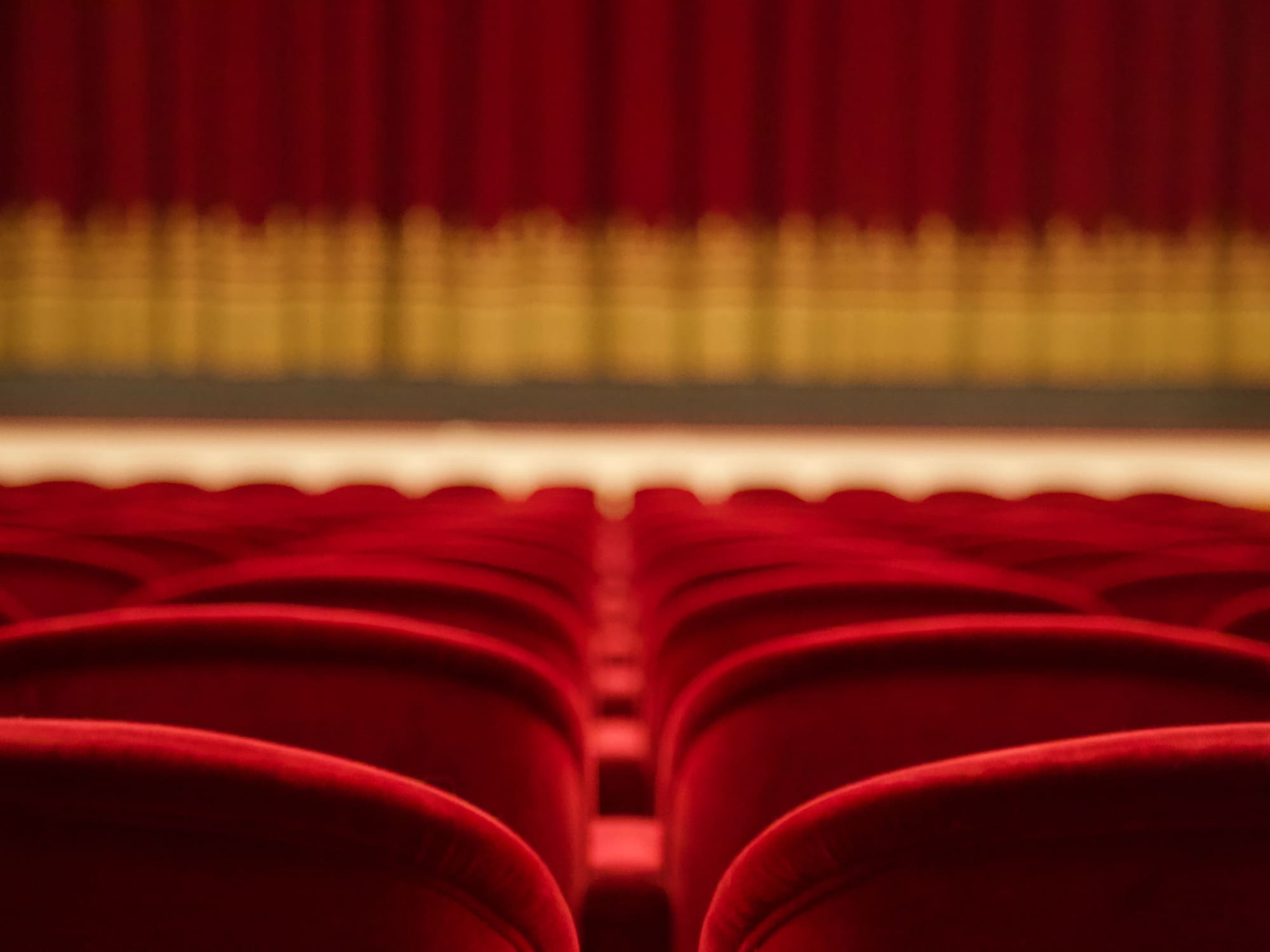 a red theater seats in a row