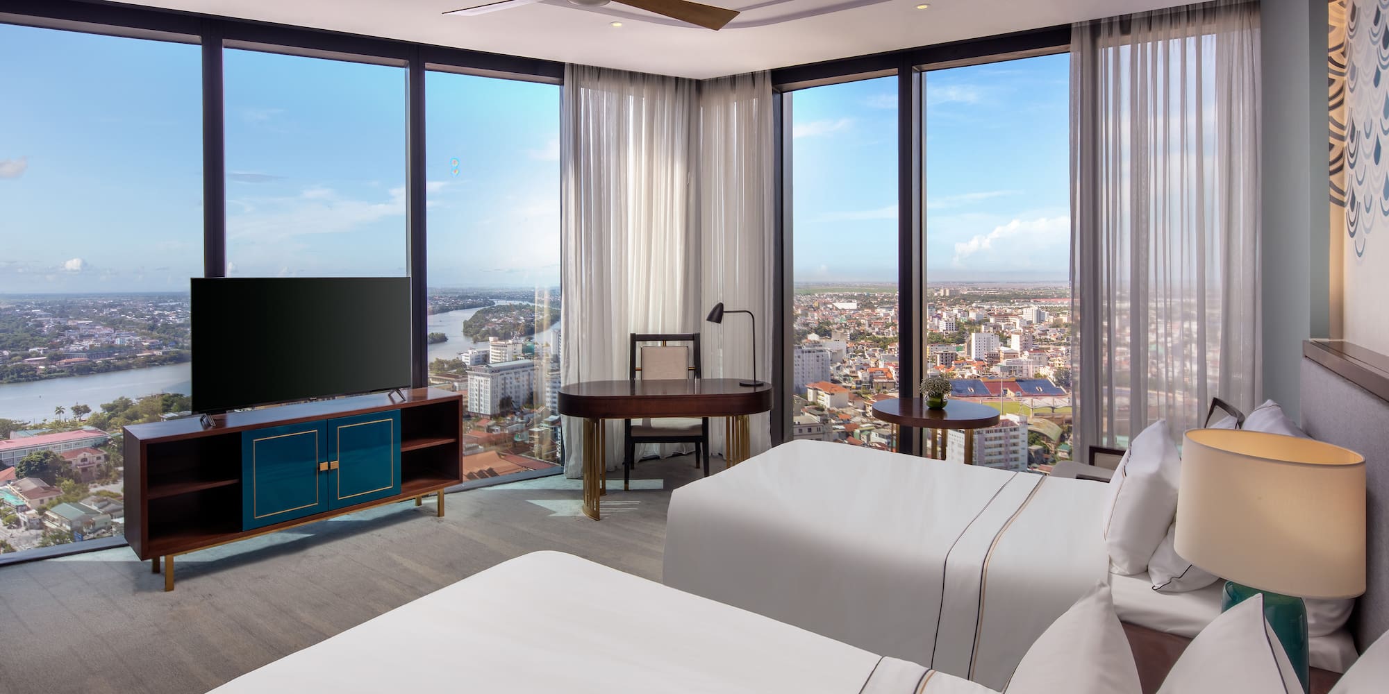 a room with two beds and a television