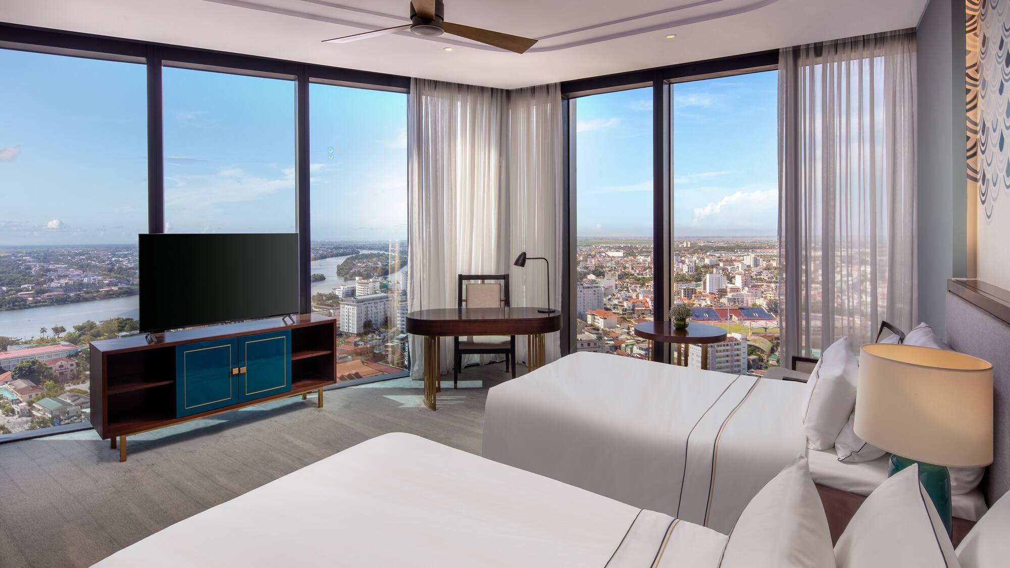 a room with two beds and a television