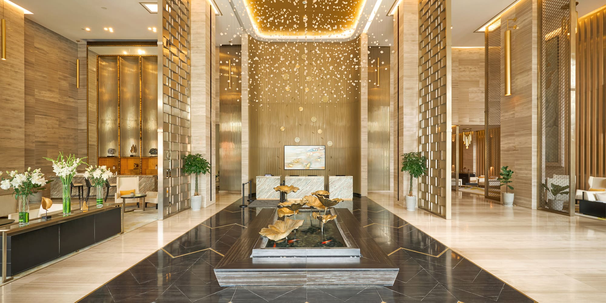 a lobby with a fountain and a large ceiling