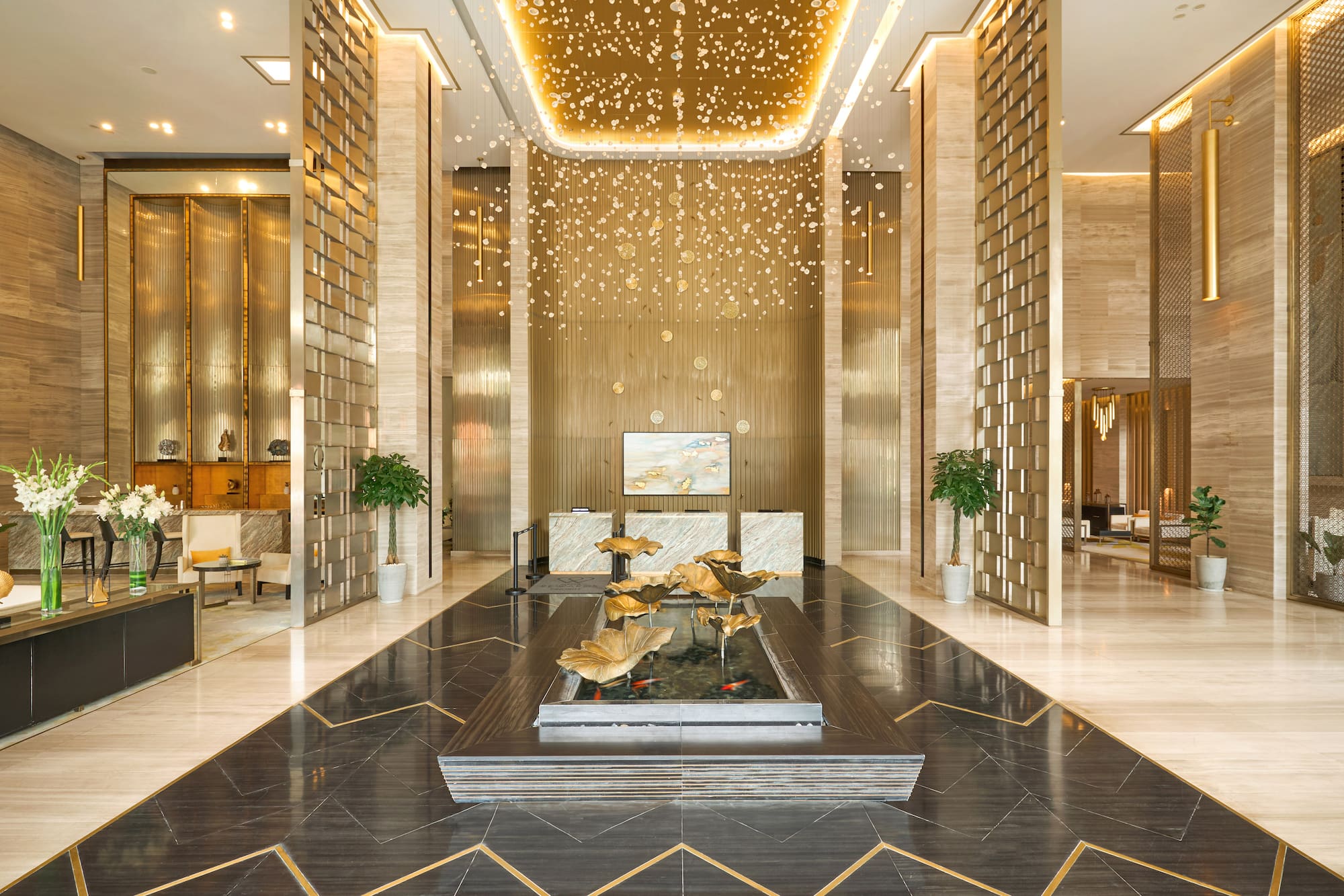 a lobby with a fountain and a large ceiling