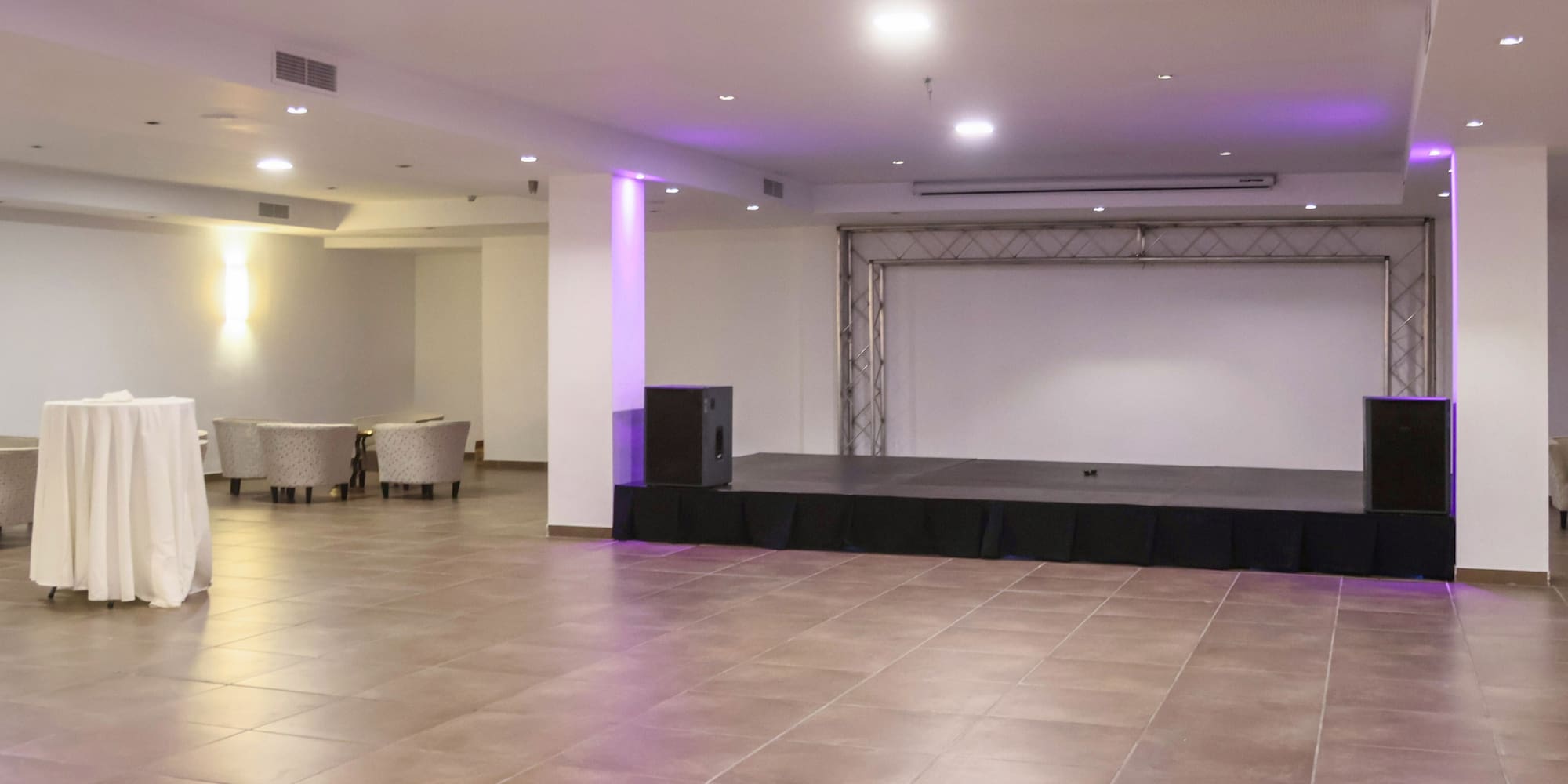 a stage in a room with purple lights