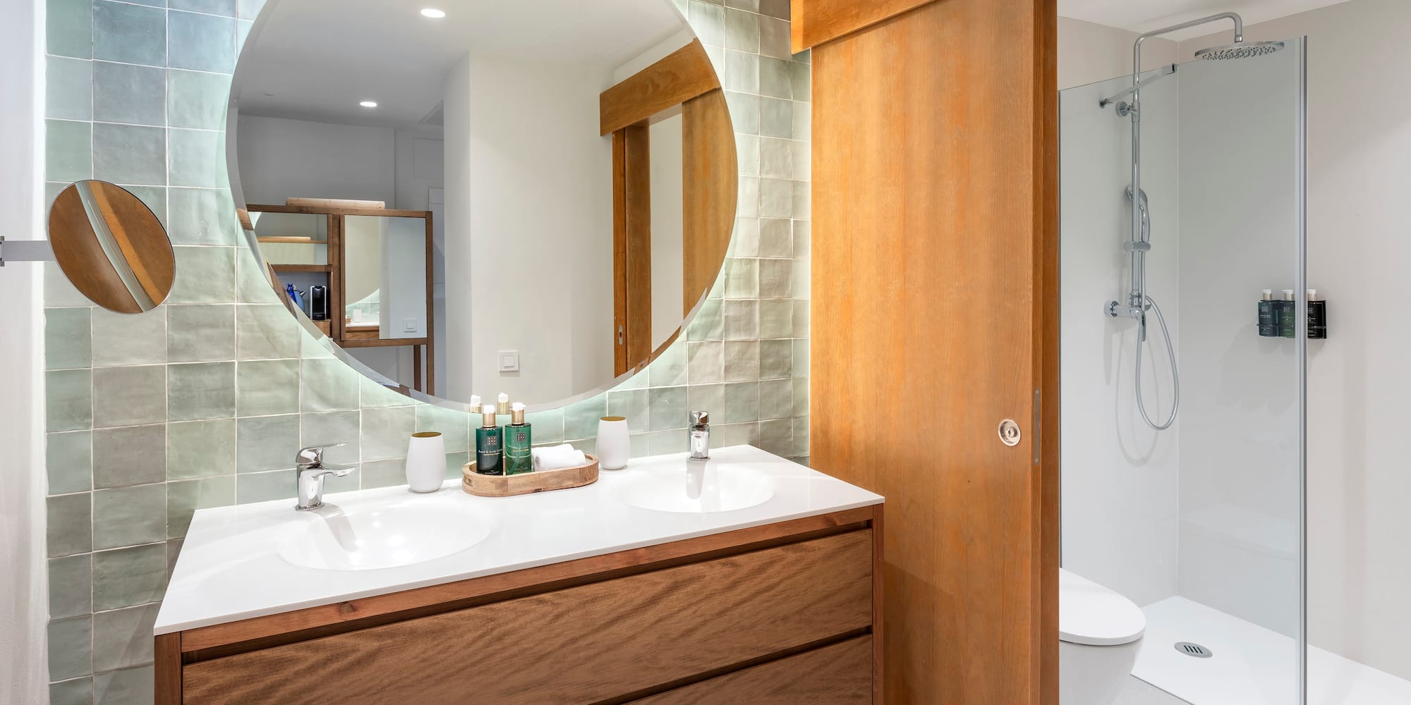 a bathroom with a round mirror