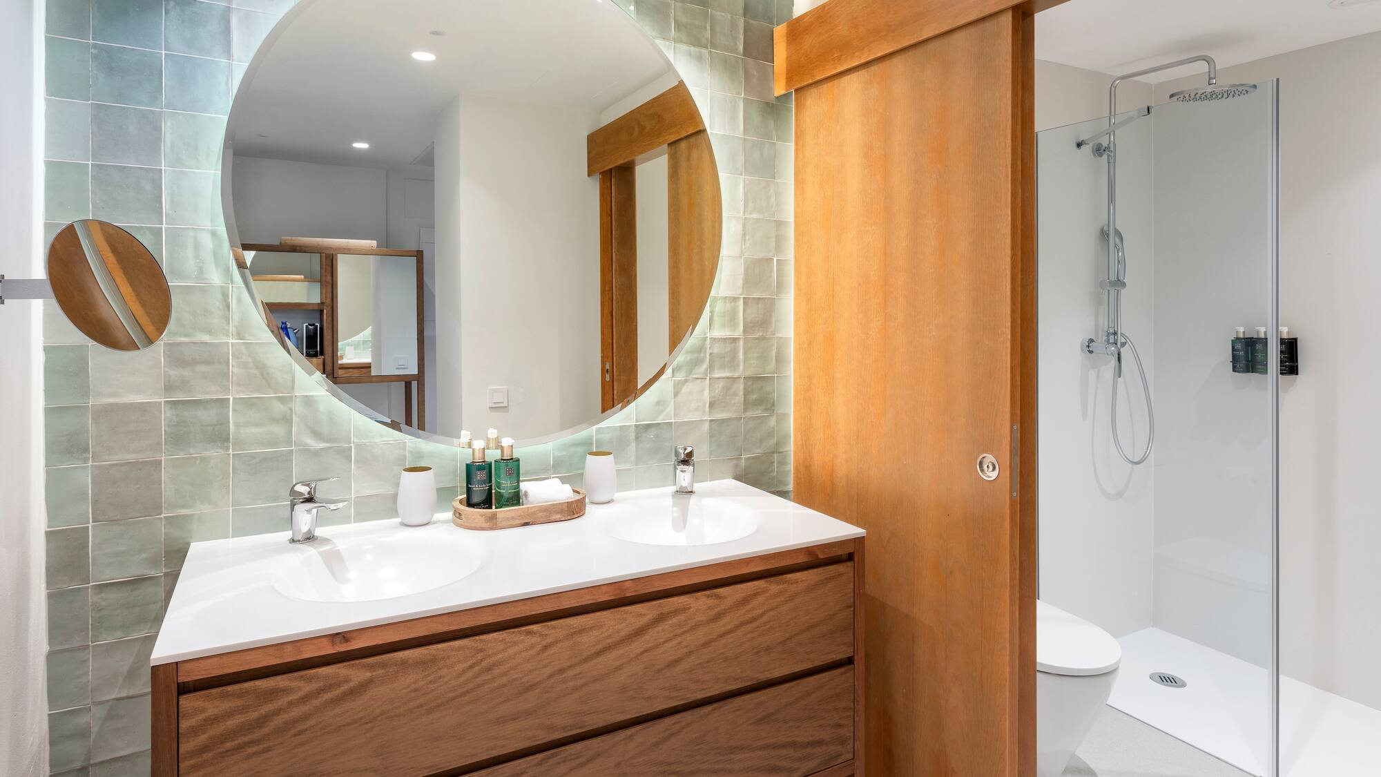a bathroom with a round mirror