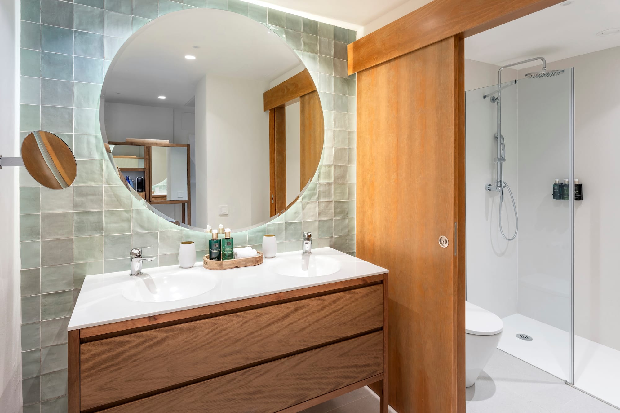 a bathroom with a round mirror