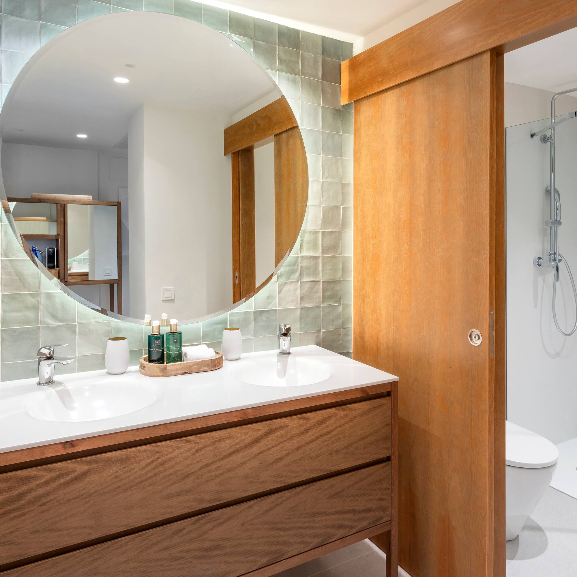 a bathroom with a round mirror