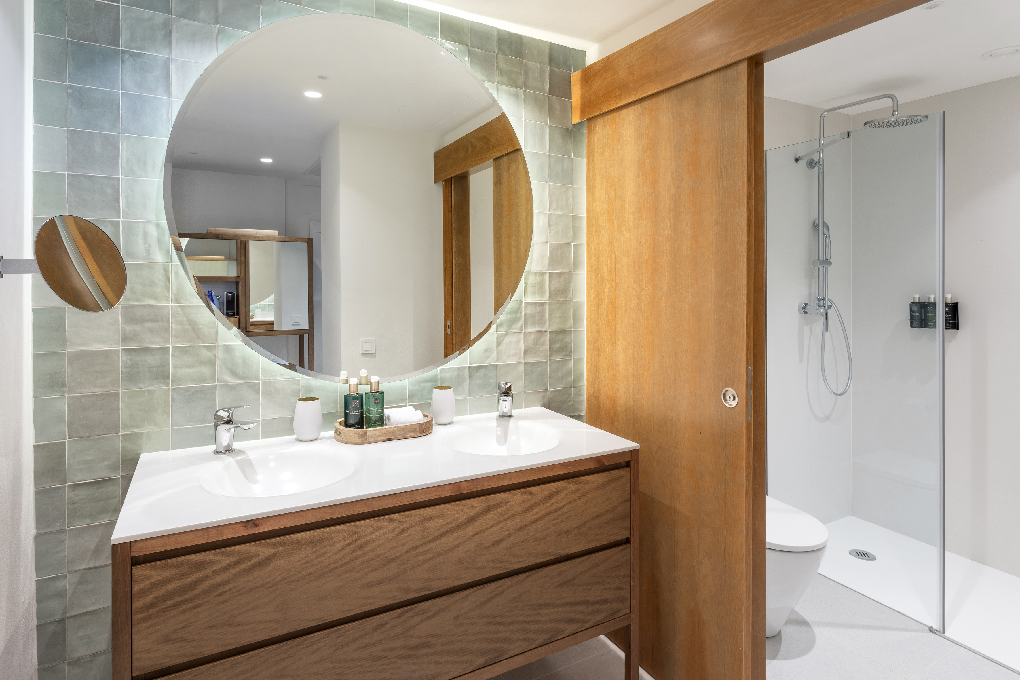 a bathroom with a round mirror