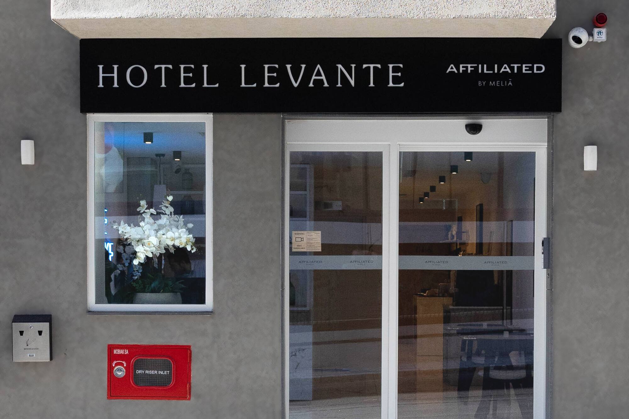 Hotel Levante main entrance, Affiliated by Meliá, with modern glass doors.