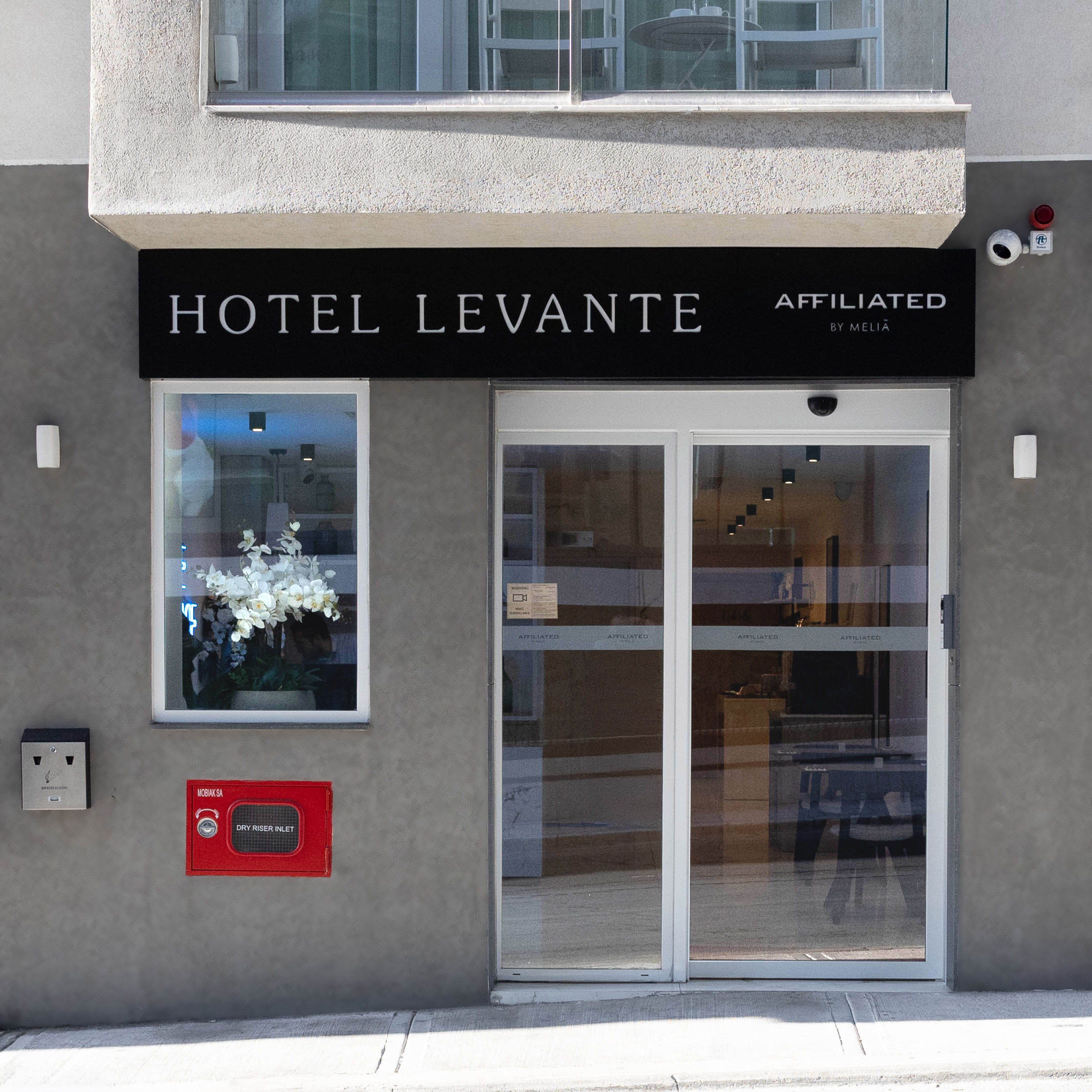 Hotel Levante main entrance, Affiliated by Meliá, with modern glass doors.