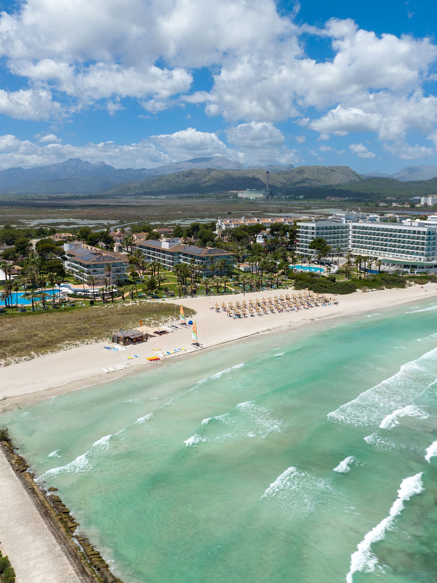 a beach with a body of water and buildings