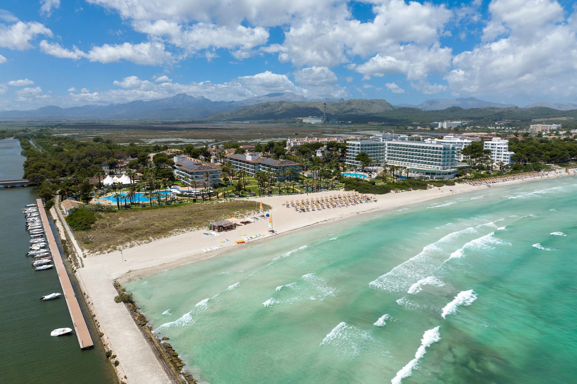 a beach with a body of water and buildings
