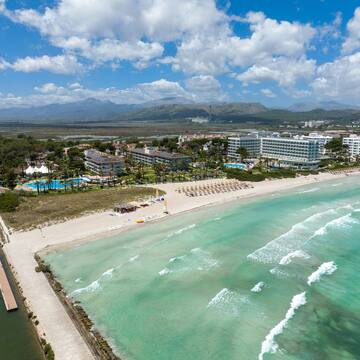 a beach with a body of water and buildings