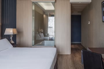 a bedroom with a glass wall