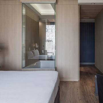 a bedroom with a glass wall