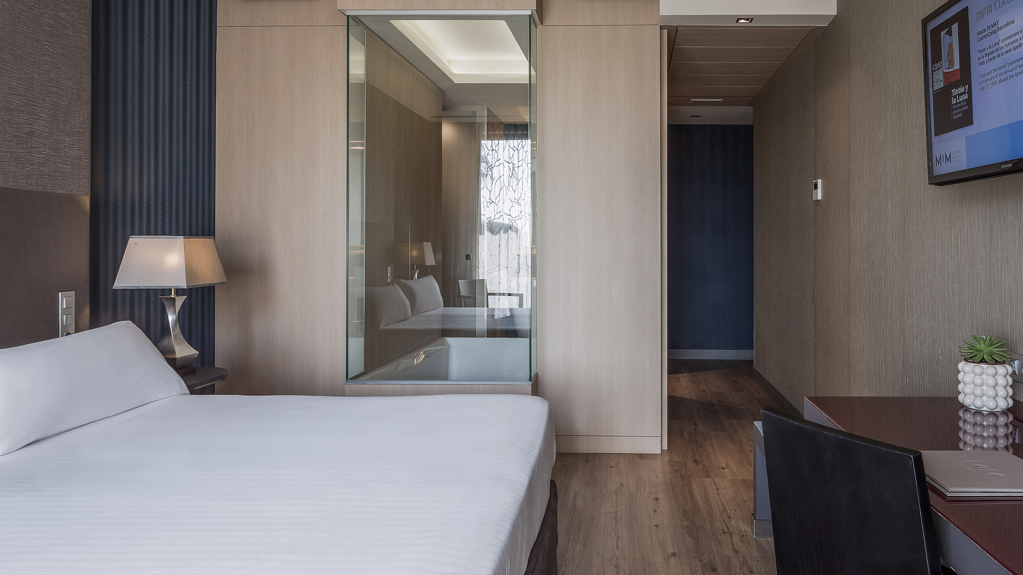 a bedroom with a glass wall
