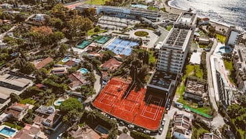 an aerial view of a tennis court and swimming pool