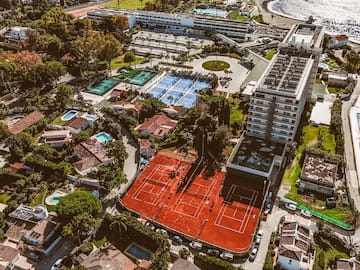 an aerial view of a tennis court and swimming pool