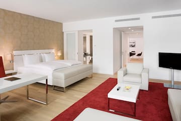 a bedroom with a red rug and white furniture