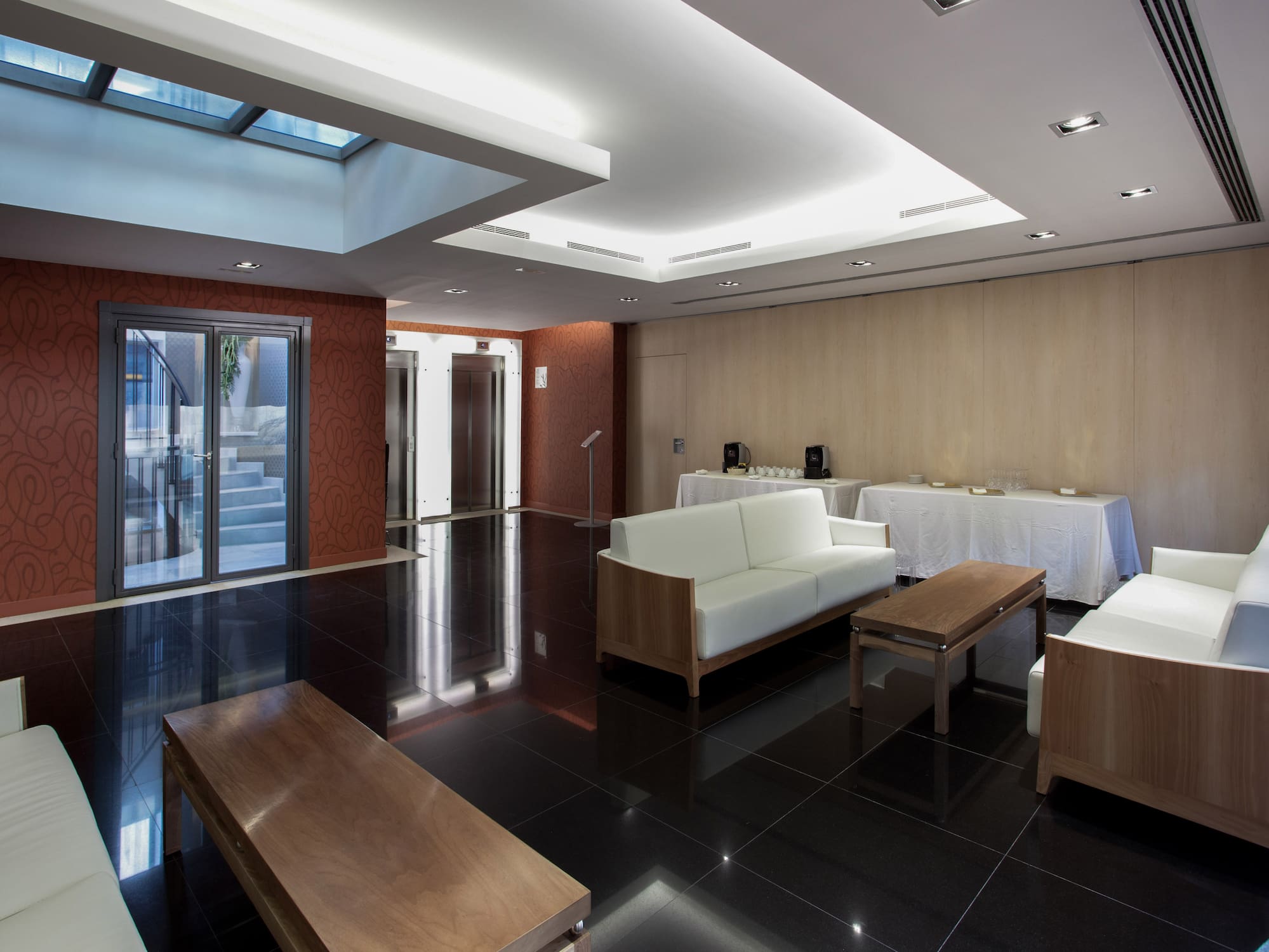 a room with white furniture and a black floor