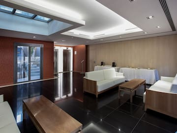 a room with white furniture and a black floor