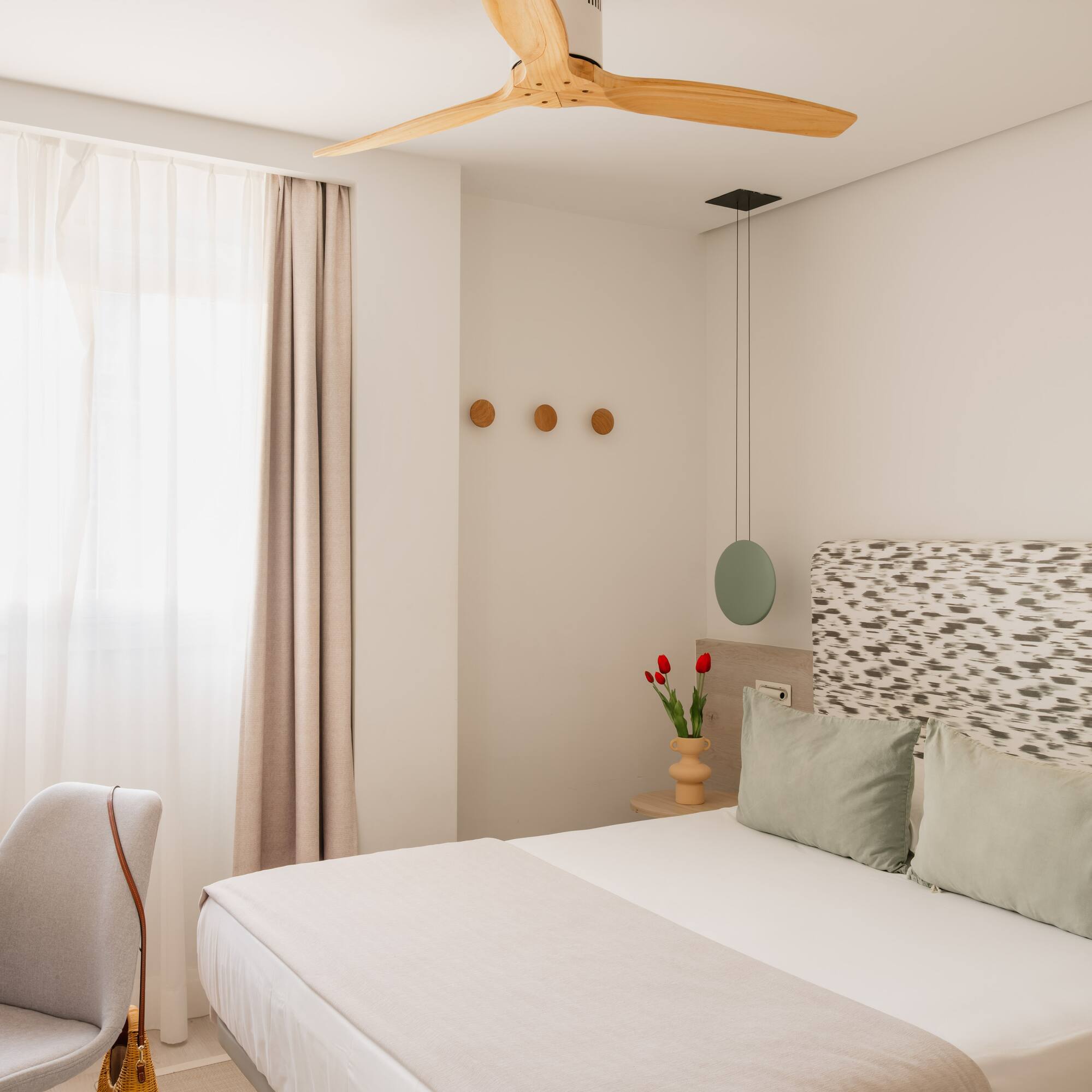 a bedroom with a fan and a bed